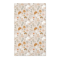 Floral nursery area rug in ochre and sage on warm oat