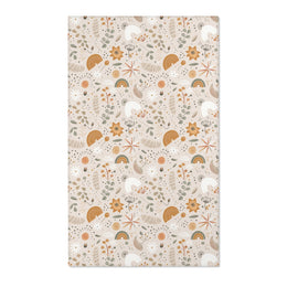Floral nursery area rug in ochre and sage on warm oat