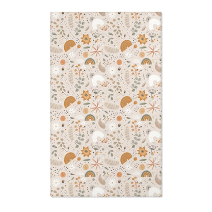 Floral nursery area rug in ochre and sage on warm oat